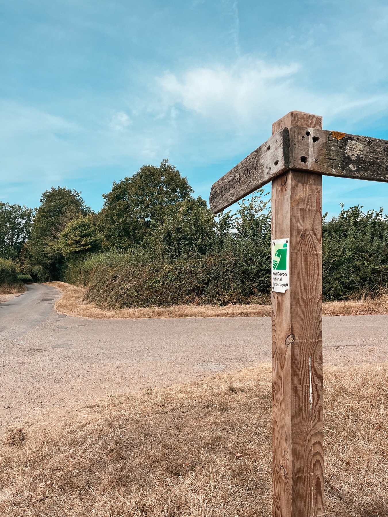 A waymarked signpost with East Devon National Landscape signage