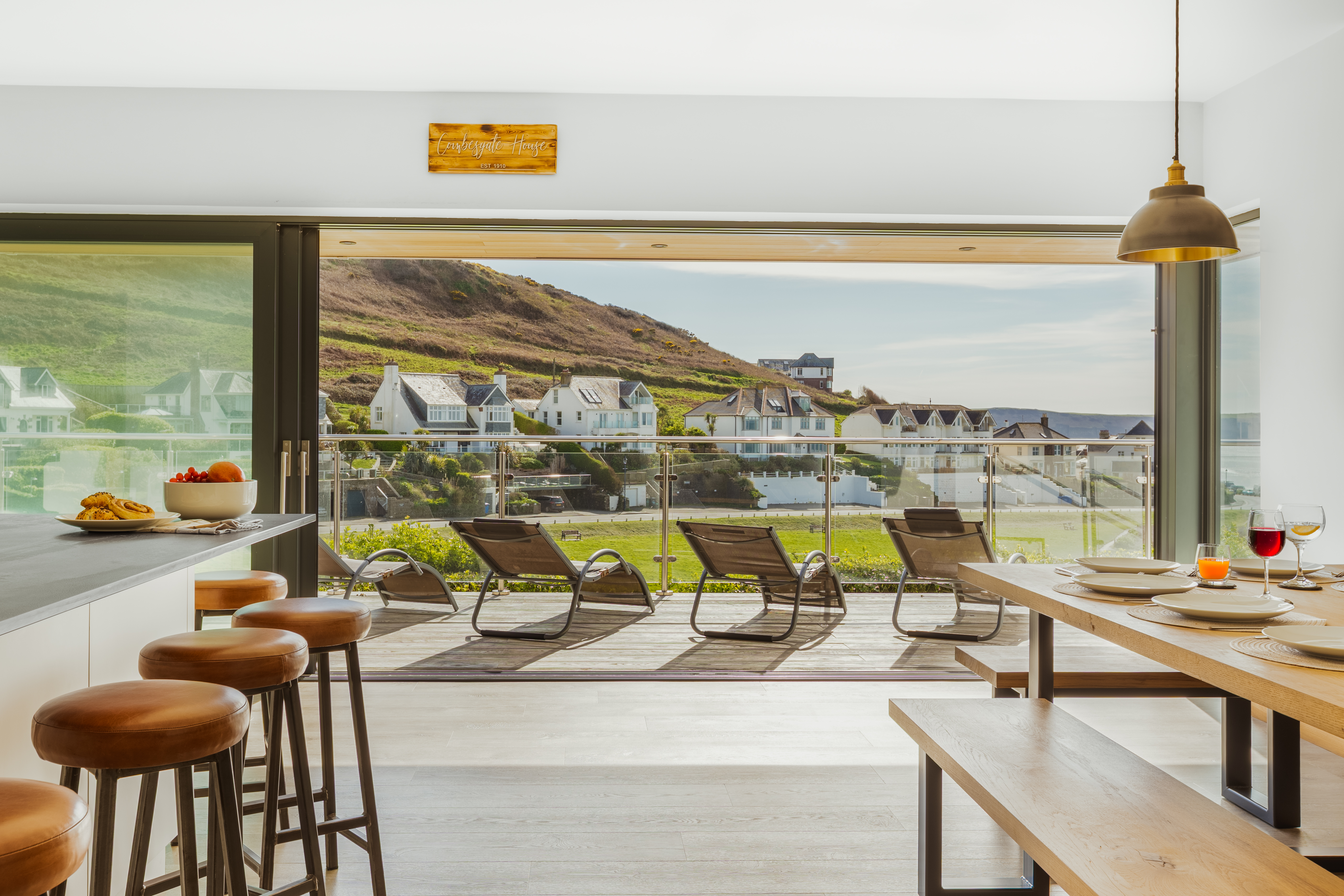 The interior with floor-to-ceiling glass and sea views at The Mortehoe Clifftop House