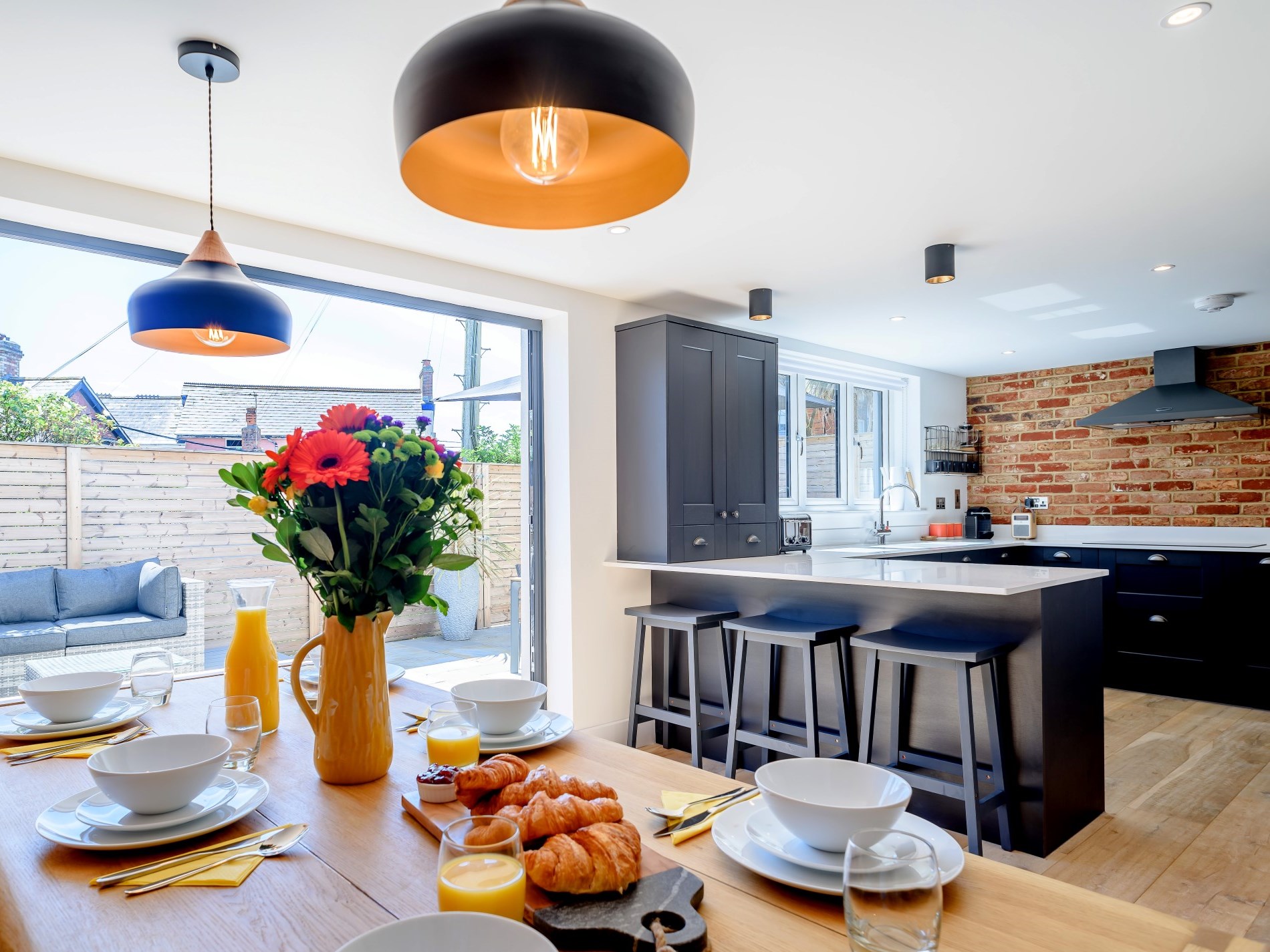 The dining area at The Bude Coastal House with Smart TV and corner sofa