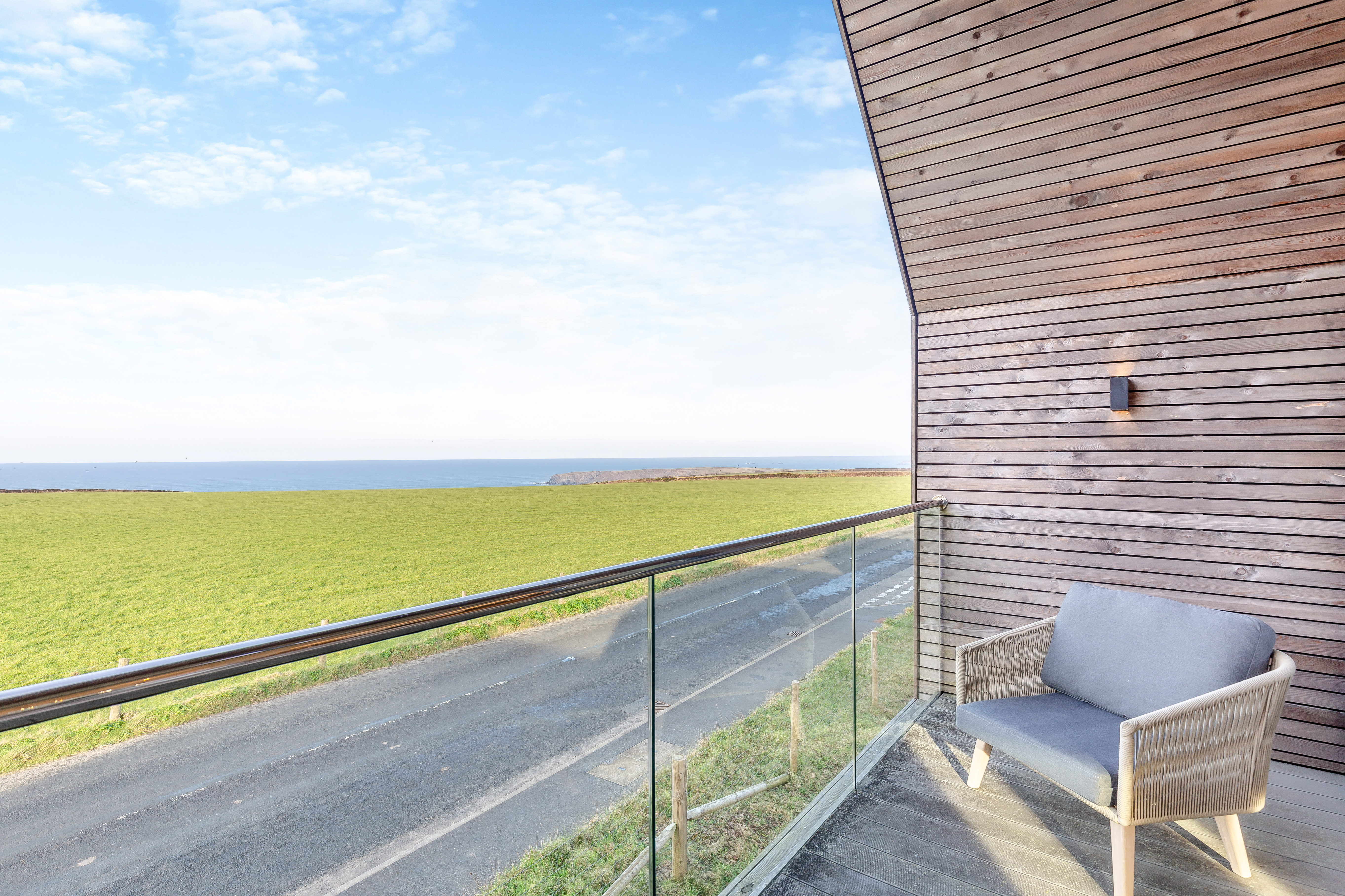 The balcony view from The Mawgan Porth House toward the Bedruthan Steps