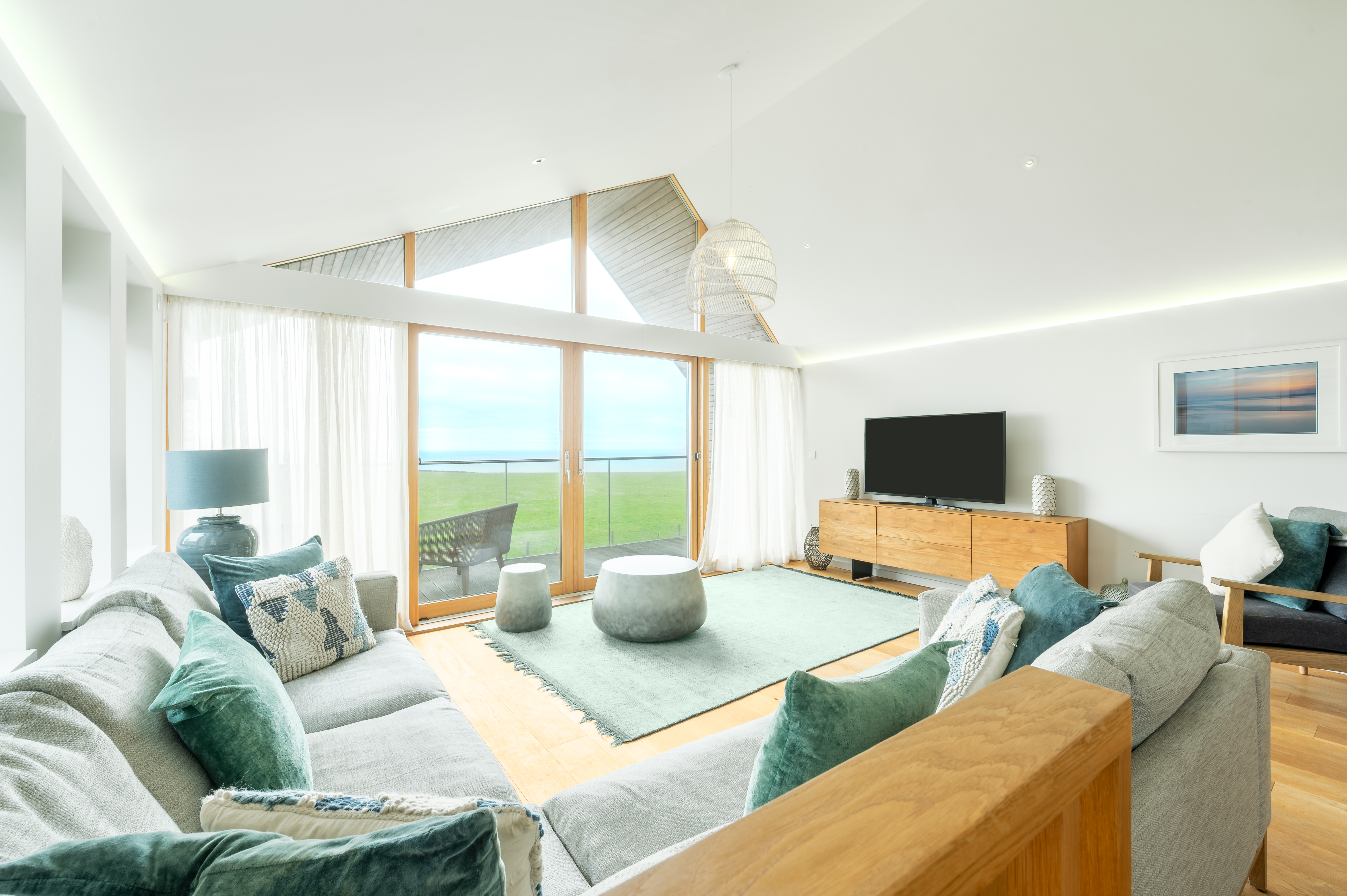 The open-plan lounge with floor-to-ceiling glass at The Mawgan Porth House, Mawgan Porth Cornwall