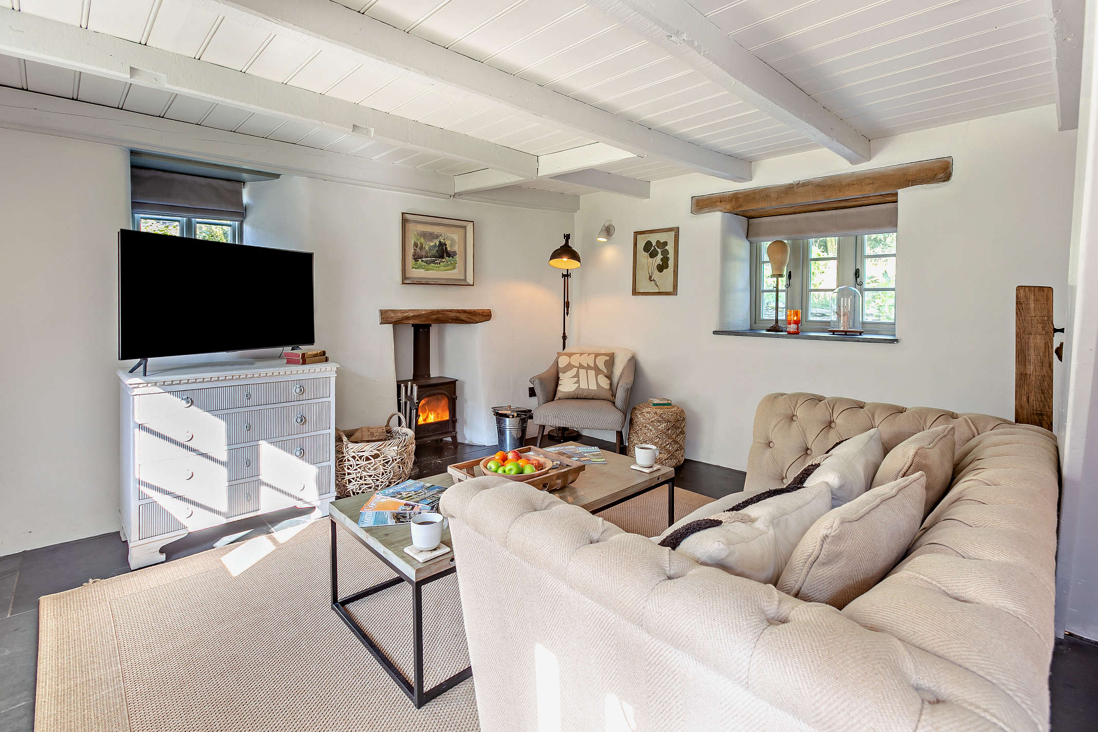 The lounge with woodburner at The Looe Cottage near Looe