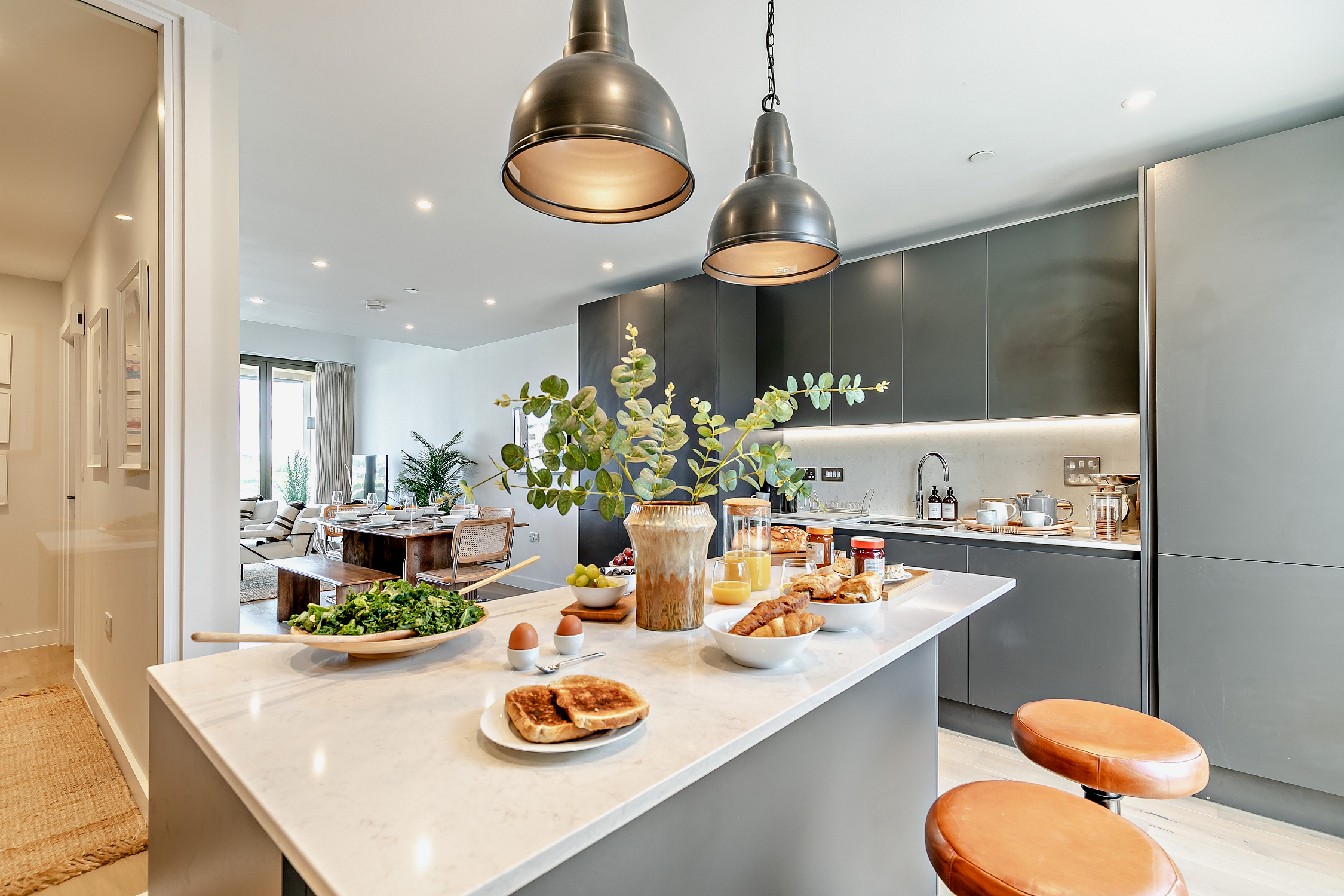 The stylish kitchen with leather bar stools at The Hayle Cottage, Hayle