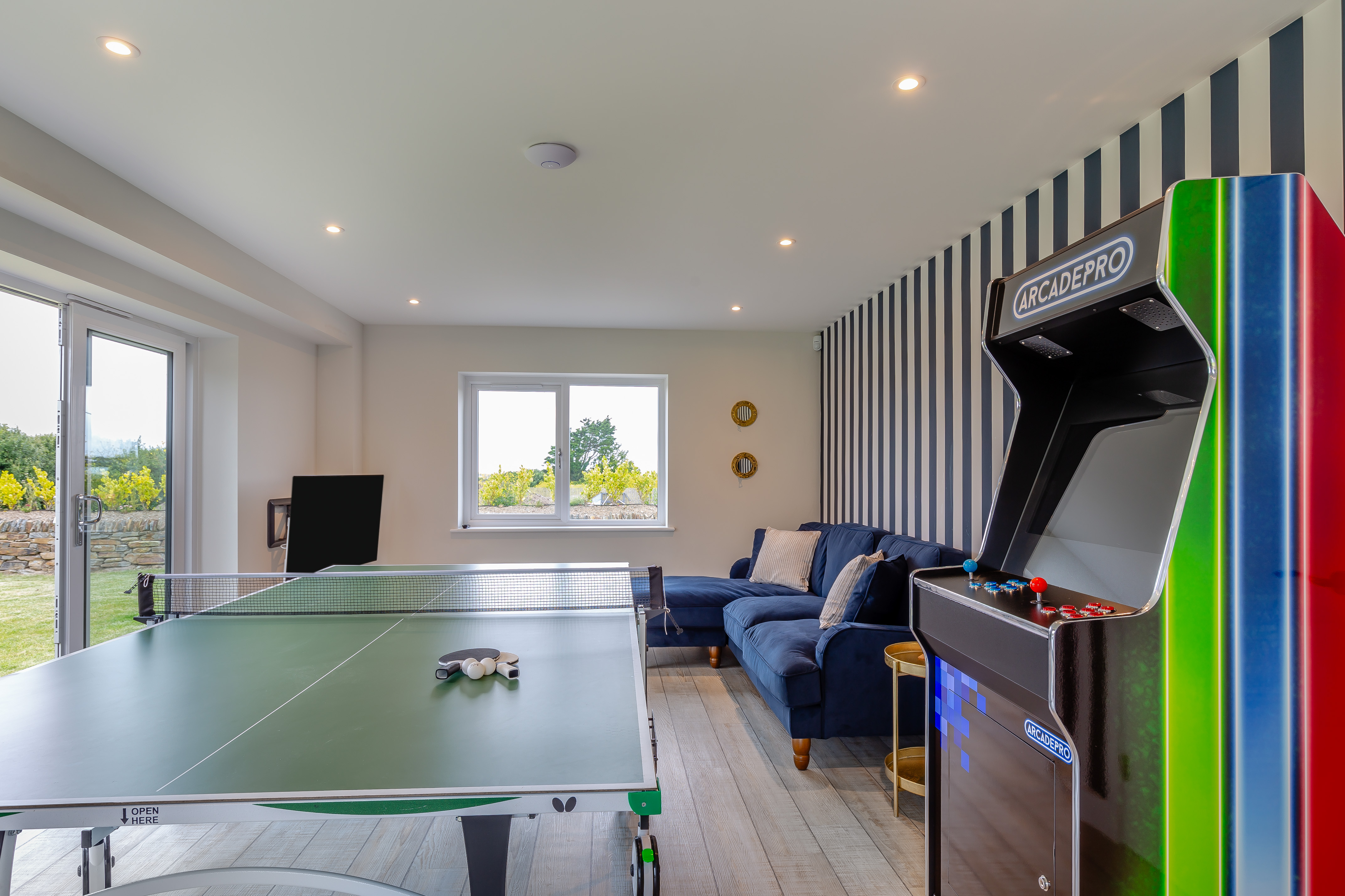 The games room with retro arcade and table tennis at The Padstow House, Padstow