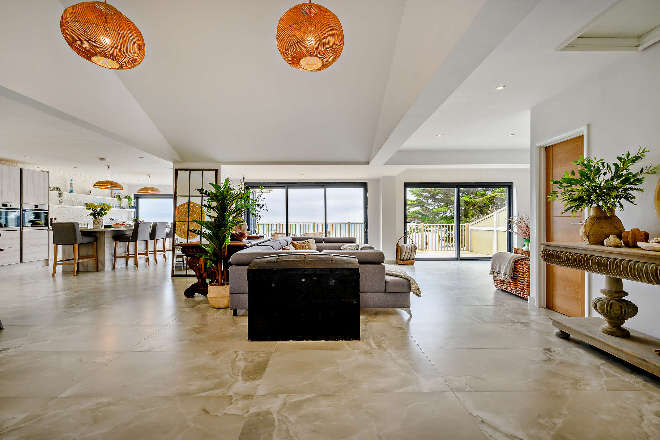 The open-plan interior at The Downderry Cottage with floor-to-ceiling sea views