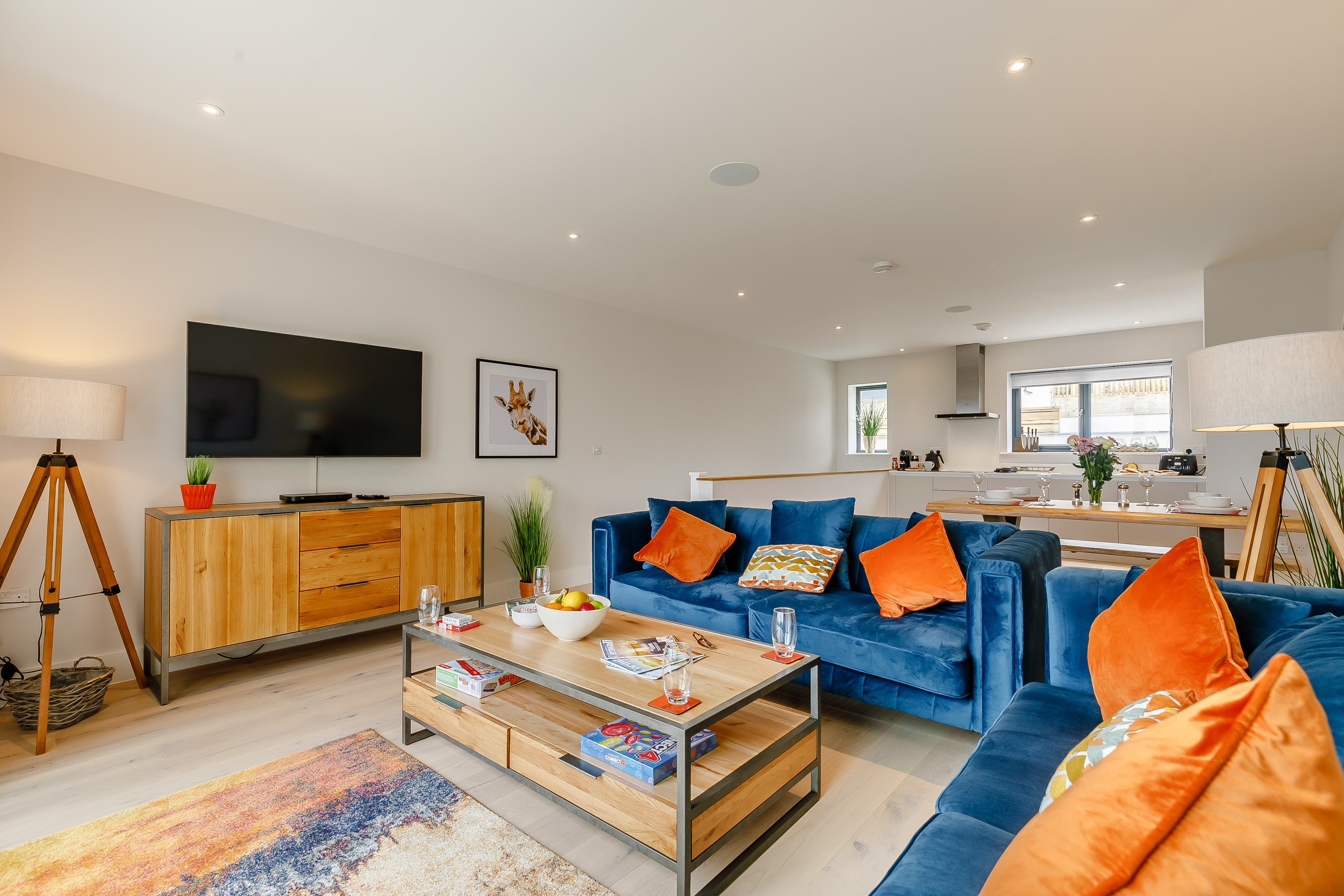 The open-plan upstairs lounge with floor-to-ceiling windows at The Newquay Apartment, Newquay