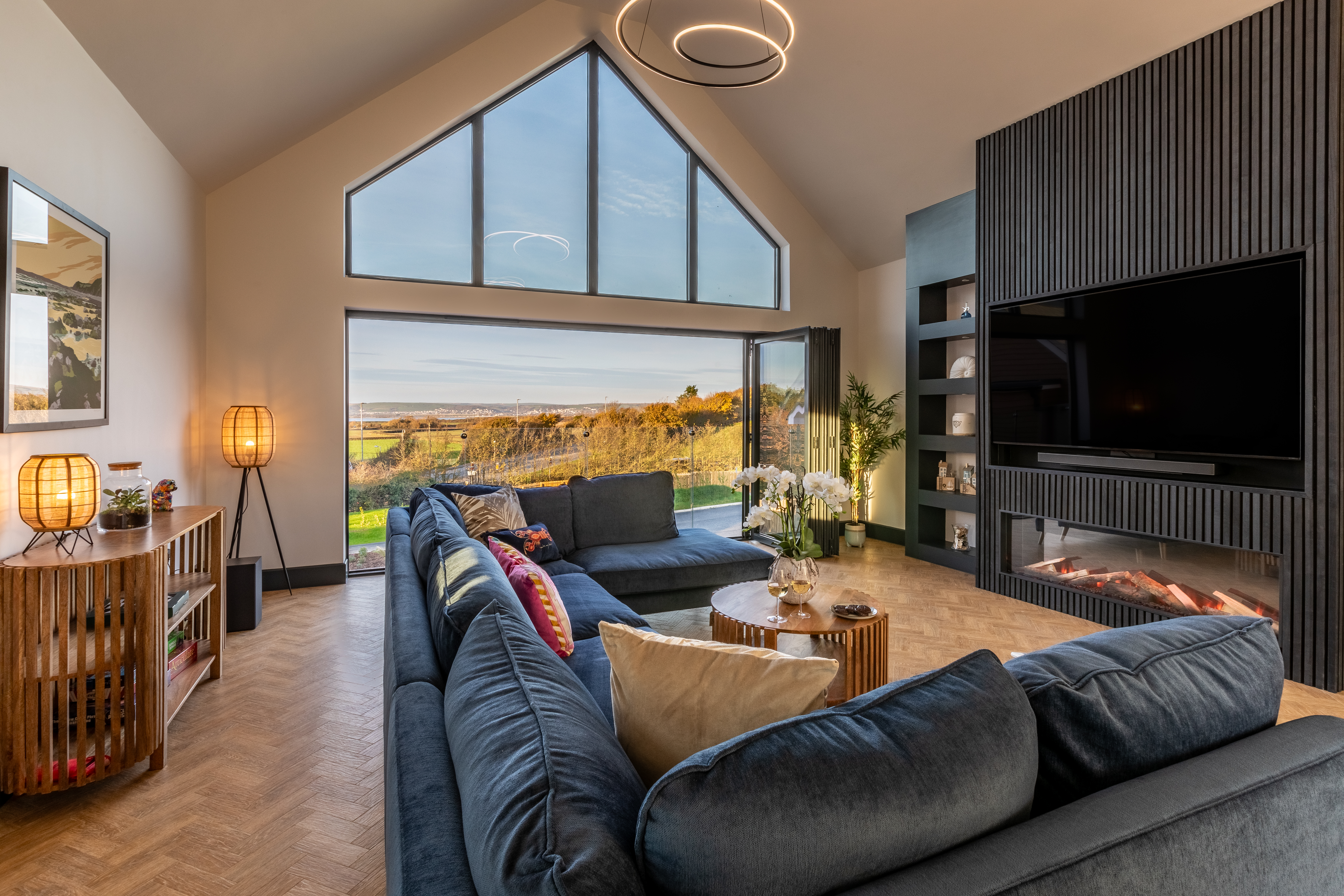 The first-floor lounge with bi-fold doors and estuary views at The Estuary House