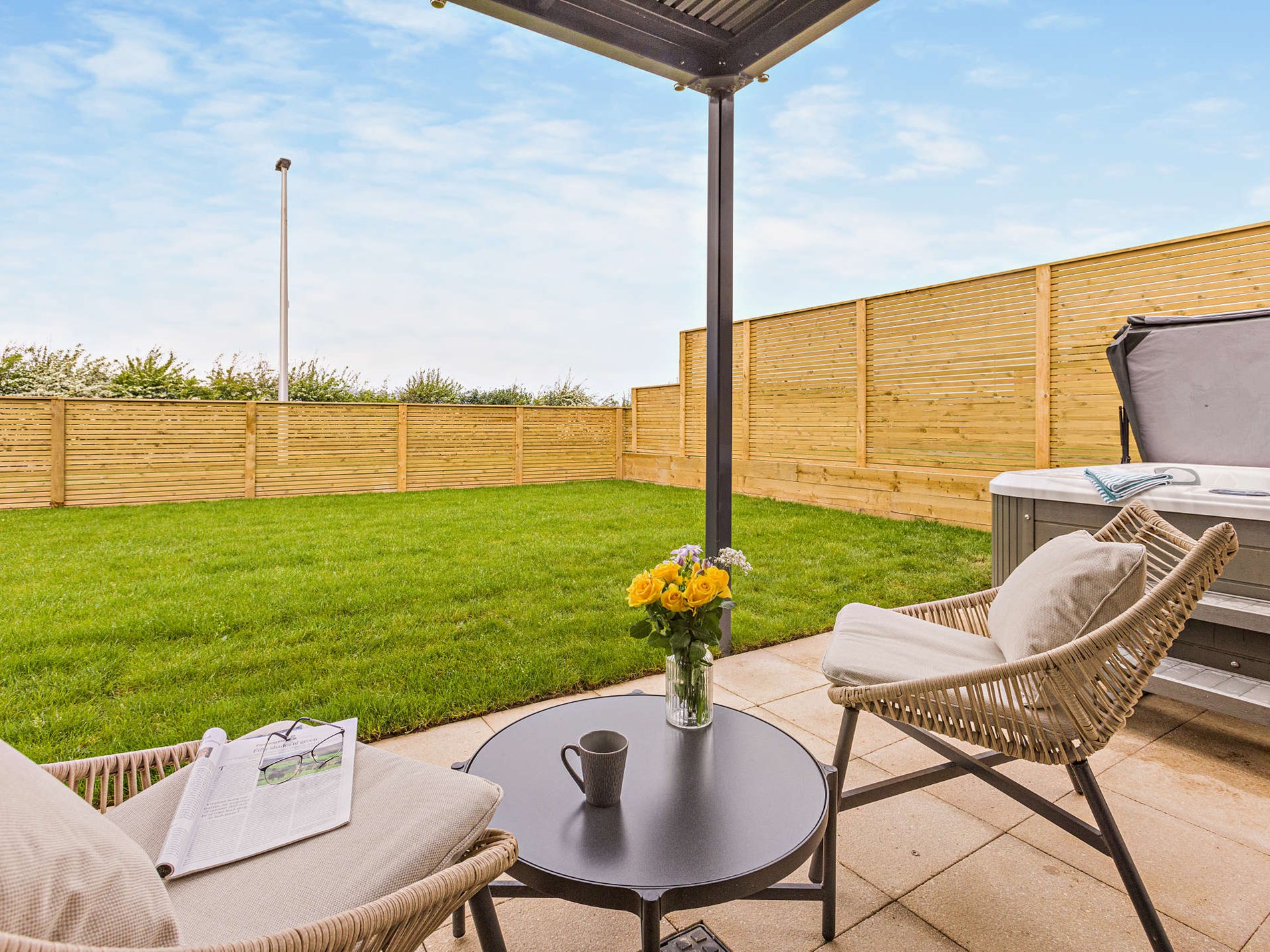 The enclosed lawned garden with hot tub at The Appledore Garden House