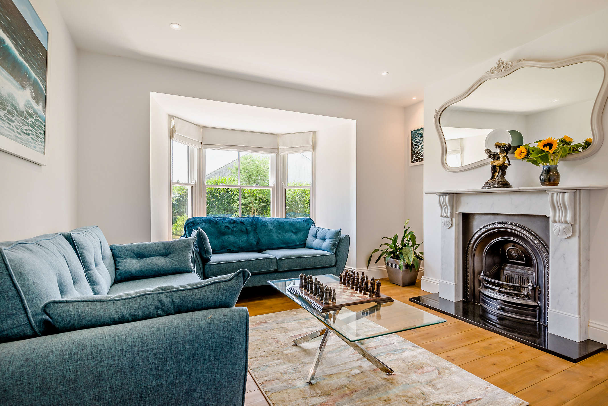 The classic sitting room at The Porthleven House with bay window and garden views