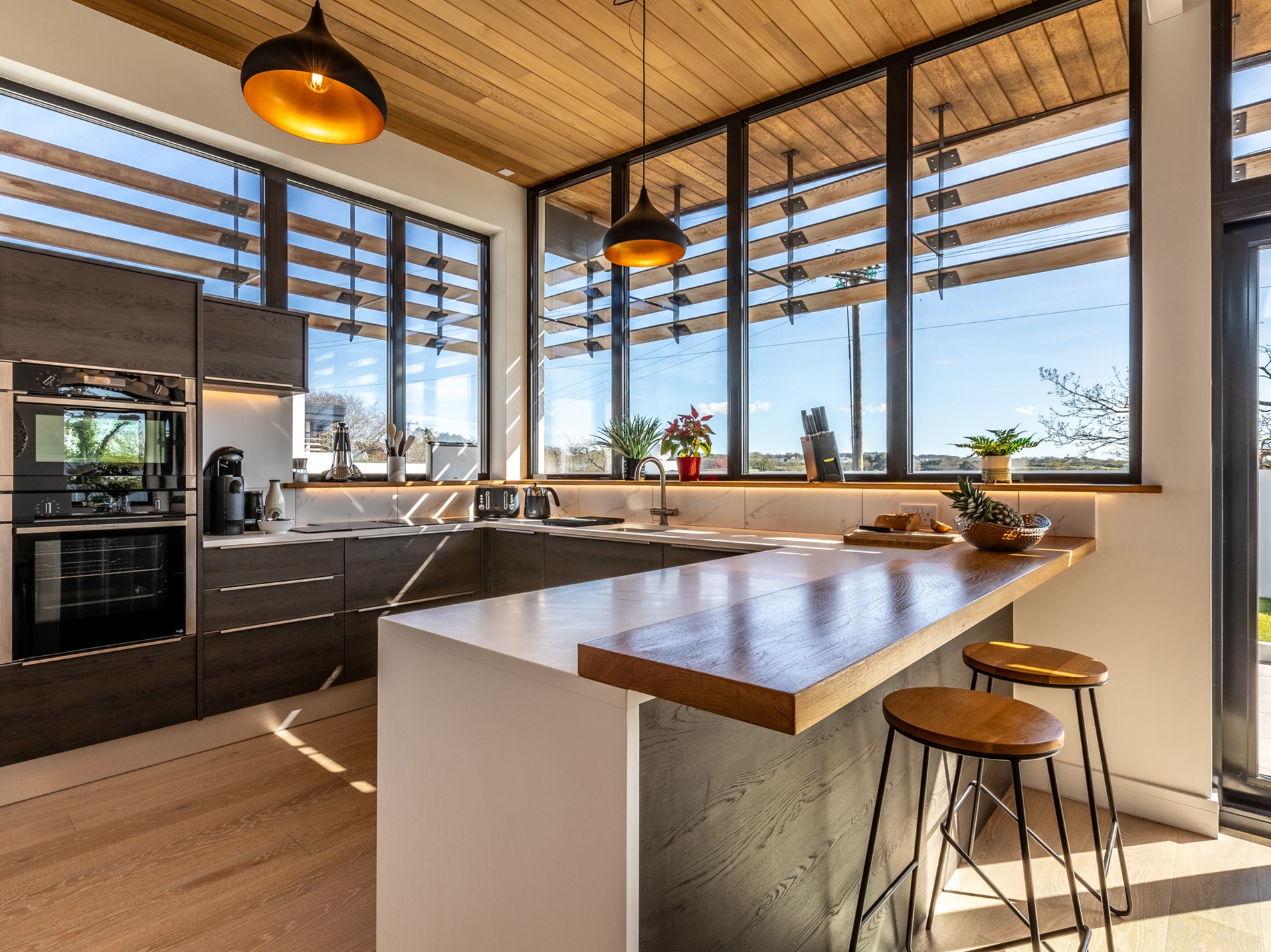 The kitchen with built-in sound system at The Tehidy House, Cornwall